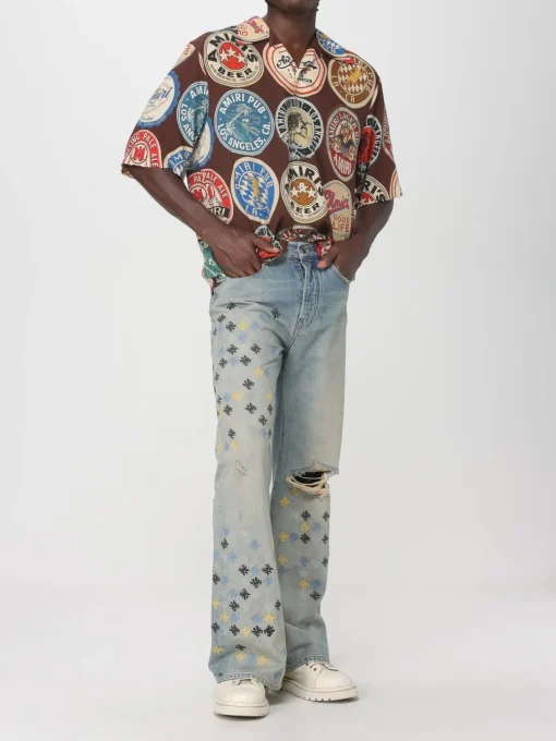 Jeans con logo all-over Amiri