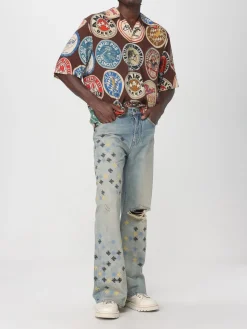 Jeans con logo all-over Amiri