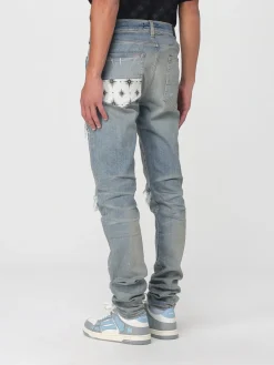 Jeans con rotture e toppe stampate Amiri