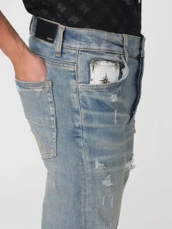 Jeans con rotture e toppe stampate Amiri